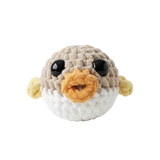 Crocheted pufferfish toy with a white background