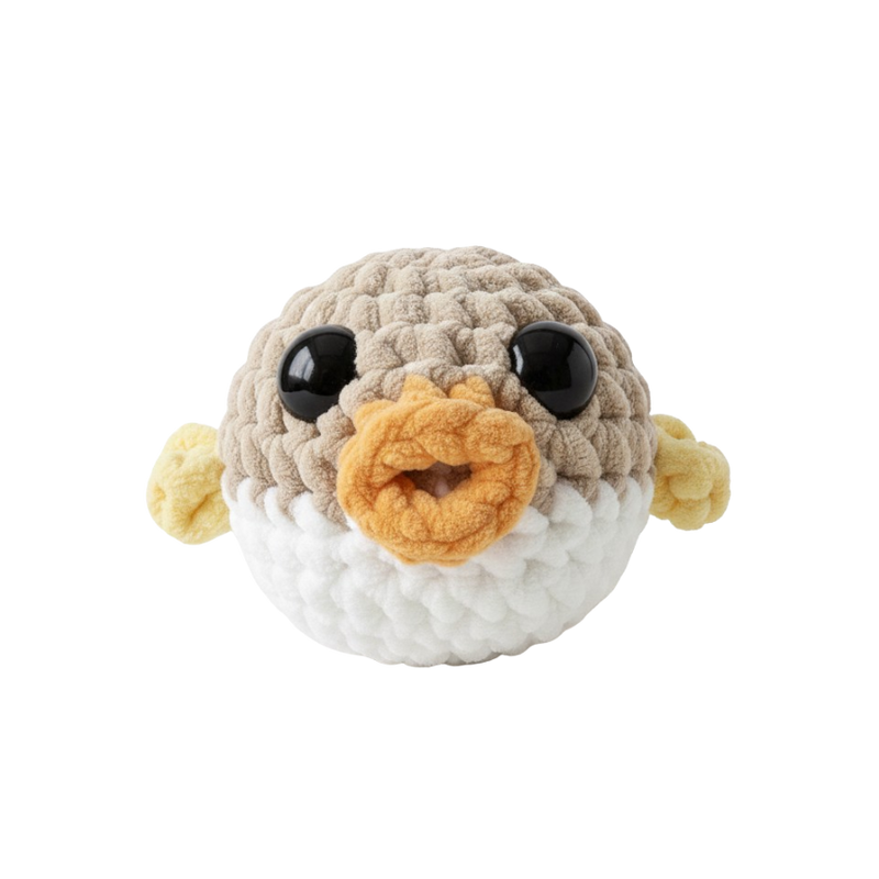 Crocheted pufferfish toy with a white background